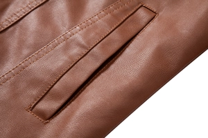 Detail view of premium brown PU leather jacket showing fine stitching and lychee texture