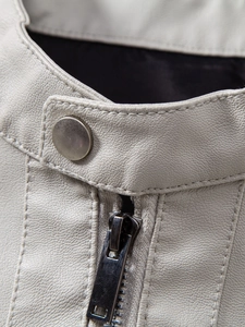 Detail of light grey PU leather jacket showing mandarin collar, metal snap button, and zipper