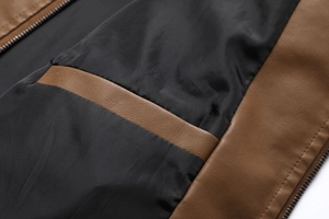 Detailed close-up of brown washed PU leather jacket inner lining and precision stitching