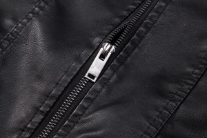 Macro detail of high-quality lychee texture black PU leather and silver metal zipper