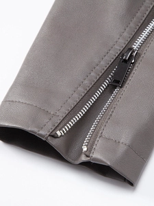 Close-up of grey PU leather jacket cuff with matte black metal zipper and stitching