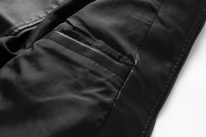 Detailed close-up showing the inner pocket and smooth metal zipper of the black leather jacket