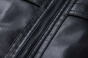 Close-up of durable zipper closure and premium stitching on black PU leather jacket