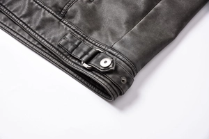 Detailed close-up of premium black PU leather jacket hem with silver metal buckles and stitching