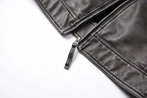 Macro shot of high-quality black PU leather texture with metal zipper and fine stitching