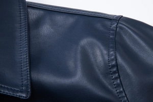 Detailed view of deep blue PU leather texture and premium stitching on a biker jacket
