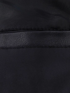 Macro detail of black PU leather and woven fabric stitching on a sleek biker jacket