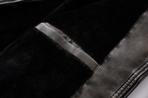 Detailed macro view of black faux fur lining and premium textured leather on biker jacket