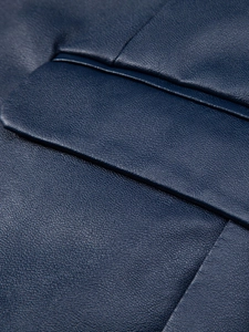 Detailed macro shot of navy blue PU leather jacket pocket with precise stitching
