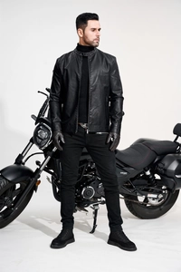 Detailed shot of a black PU motorcycle jacket with stand collar and sleek metal zipper