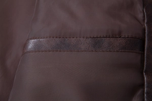 Detailed view of the dark brown PU leather jacket's interior lining and stitching