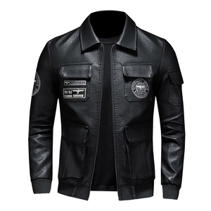 Detail of black faux leather biker jacket with embroidered badges and four pockets