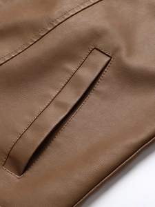 Brown leather jacket detail featuring washed PU texture and double-stitched pocket design