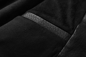 Detail of premium black faux leather jacket showing soft fleece lining and texture