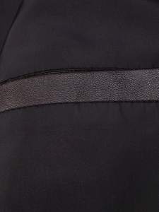 Detail of black textile fabric with brown lychee grain leather strip on a men's jacket