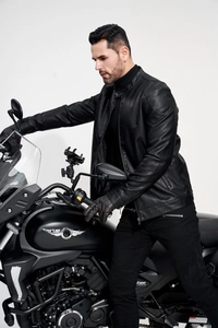 Close-up of men's black faux leather biker jacket featuring a sleek stand collar design