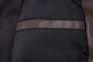 Close-up of durable brown lychee grain PU leather with high-quality stitching and black lining