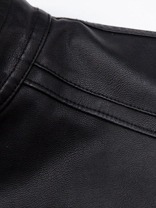 Detailed close-up of premium black PU leather with litchi grain texture and double stitching