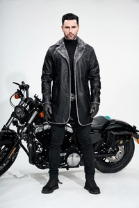 Detail of men's long PU leather jacket with gray faux fur collar and biker style design