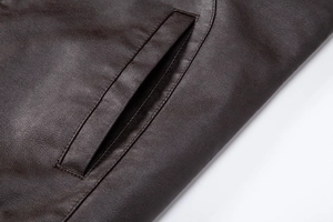 Detail of premium brown faux leather jacket showing durable side pocket and fine stitching