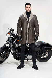 Close-up of men's brown leather coat featuring a thick grey fleece lining and lapels