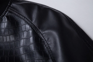Detailed close-up of black PU jacket shoulder featuring faux crocodile texture stitching