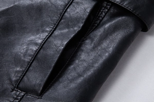 Close-up of black PU leather jacket showing detailed stitching and pocket craftsmanship