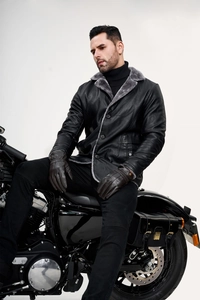 Detail of men's leather jacket with grey faux fur collar and warm fleece lining