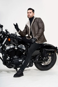 Detail of men's brown PU leather jacket with faux fur collar on a black motorcycle