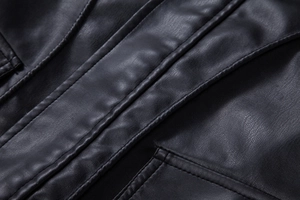 Macro shot of reinforced stitching and premium faux leather texture on black moto jacket