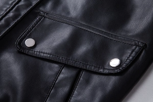 Macro shot of faux leather motorcycle jacket pocket with silver metal snap buttons