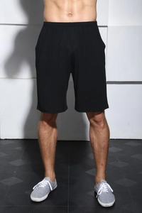 Detail of men's black athletic shorts featuring elastic drawstring waistband and breathable fabric