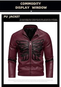 Detailed close-up of a burgundy PU leather jacket with skull embroidery and a stand collar