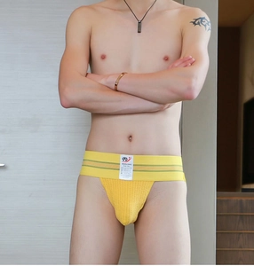Front detail of men's yellow sports underwear with wide elastic striped waistband