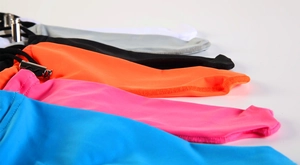 Close-up of multicolor elastic arm sleeves featuring adjustable silver metal buckles