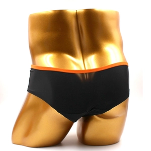 Detail of black men's briefs with orange waistband on a golden mannequin for a snug fit