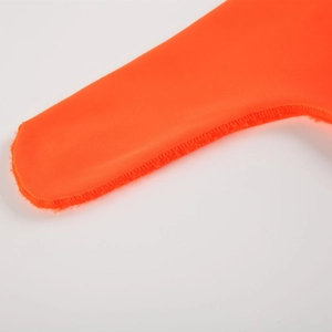 Close-up of bright orange men's thong with reinforced stitching and elastic fabric