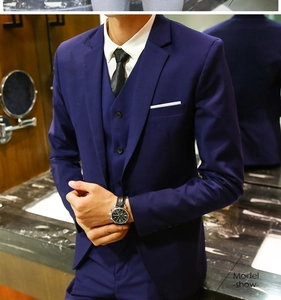 Detail of slim fit navy blue 3-piece suit with notch lapel and white pocket square
