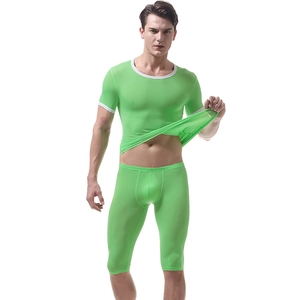 Close-up of elastic ice silk fabric being stretched on green men's thermal base layer