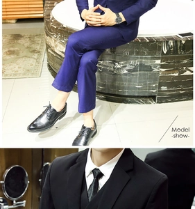 Detail view of slim fit three-piece navy business suit with matching vest and tie