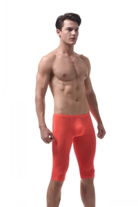 Macro detail of men's orange ice silk sports shorts with 3D pouch and elastic fabric