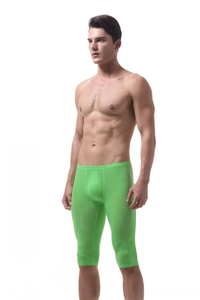 Detailed close-up of men's neon green ice silk sports shorts with elastic slim fit design