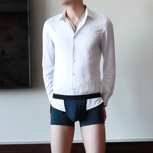 Detail showing white long-sleeve shirt with navy blue men's boxer briefs on a model