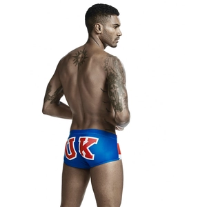 Detail view of men's blue swimming trunks with UK print and red side stripes
