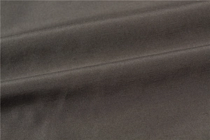 Detailed macro view of dark grey thick woven fabric texture on a men's vest garment