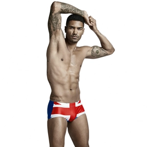 Detailed shot of men's low-waisted square-cut swim trunks with vibrant UK flag print pattern