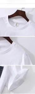 Detail view of white cotton-linen T-shirt featuring denim pocket and ribbed crew neck