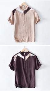 Detail of men's linen t-shirt featuring color-block design and buttoned stand collar