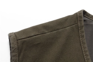 Detail of army green cotton vest shoulder showing high-quality stitching and twill fabric texture