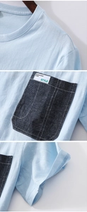 Detailed view of light blue cotton T-shirt featuring a denim chest pocket and woven label